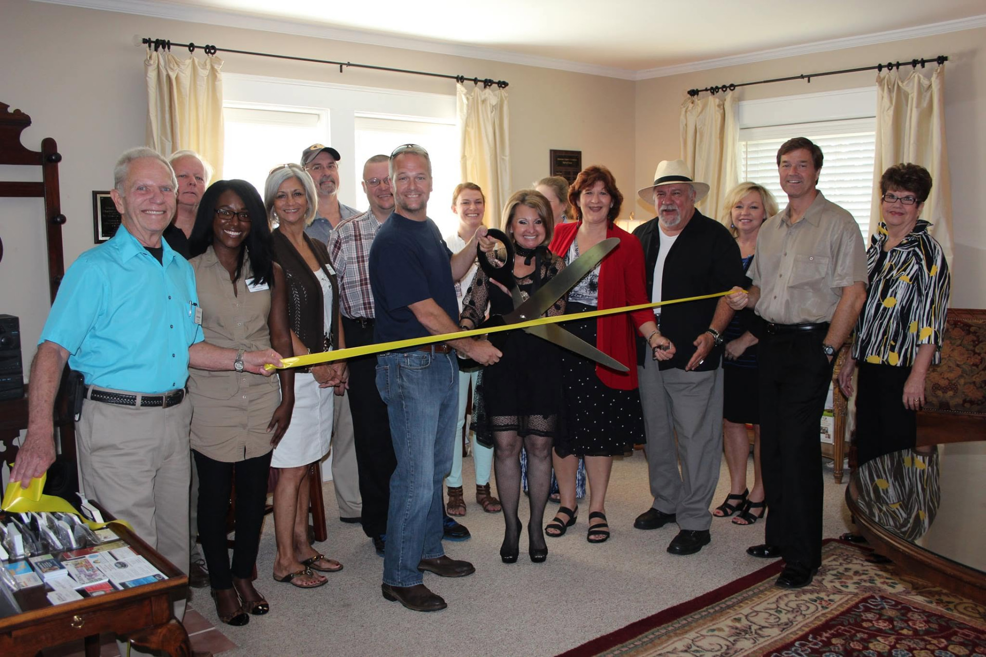 Woody Barrett and Lynn Trehern cutting the ribbon with the Clayton community